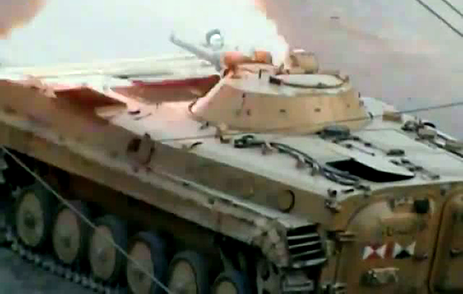 An image grab taken from a video uploaded on YouTube on July 17, 2012 allegedly shows a tank from forces loyal to Syria's President Bashar al-Assad firing a round in the city of Saqba, in Damascus province. AFP PHOTO/YOUTUBE