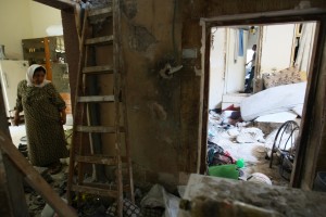 A Palestinian woman walks through the destroyed home of the Haruf family after Israeli forces carried out a raid on the abode in the West Bank City of Nablus on 28 July 28 (photo: AFP/JAAFAR ASHTIYRH)  