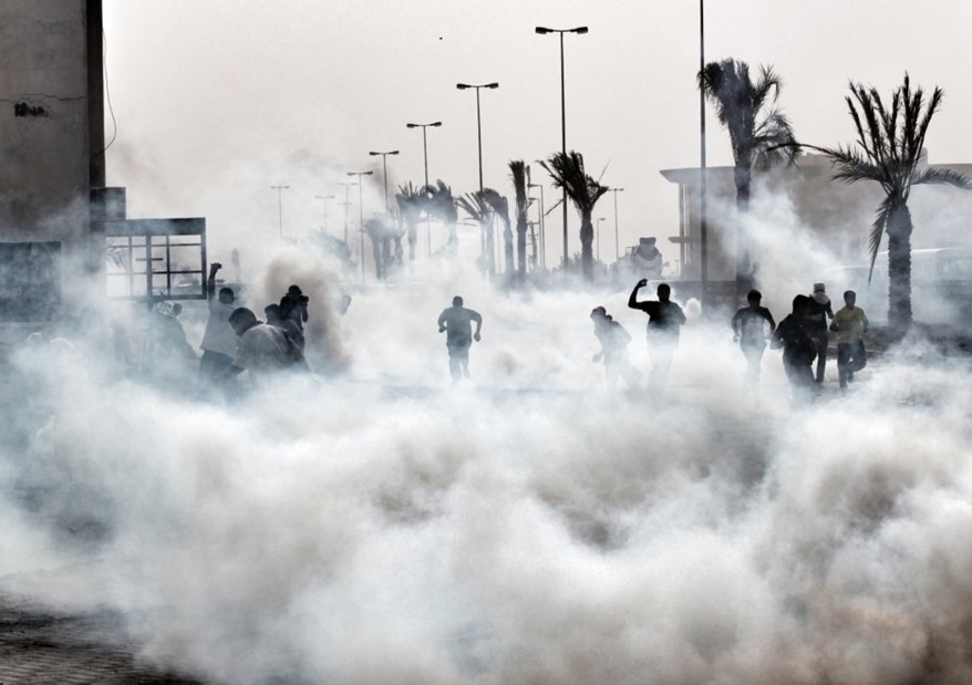 A handout picture released by Bahrain’s main opposition Al-Wefaq group shows protesters engulfed in tear gas fired by police during a demonstration in a Shia village close to Manama (file photo: AFP/Ho/Al-Wefaq Media Centre)
