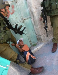 An Israeli border policemen violently arrests a Palestinian boy who joined a peaceful demonstration to mark “Naksa Day”, the 44th anniversary of the 1967 Six Day War in the West Bank town of Hebron on 5 June 2012 (AFP PHOTO / HAZEM BADER)