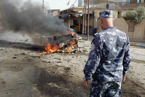 An Iraqi security officer arrives on the scene at a bombing in Iraq (AFP/file)