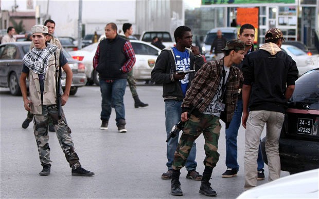 Militia members man a checkpoint in Tripoli. A top-level commander was recently shot at by militiamen in Libya (AFP/file)