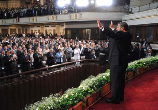 President Morsy addresses the crowd before his speech at Cairo University (AFP)