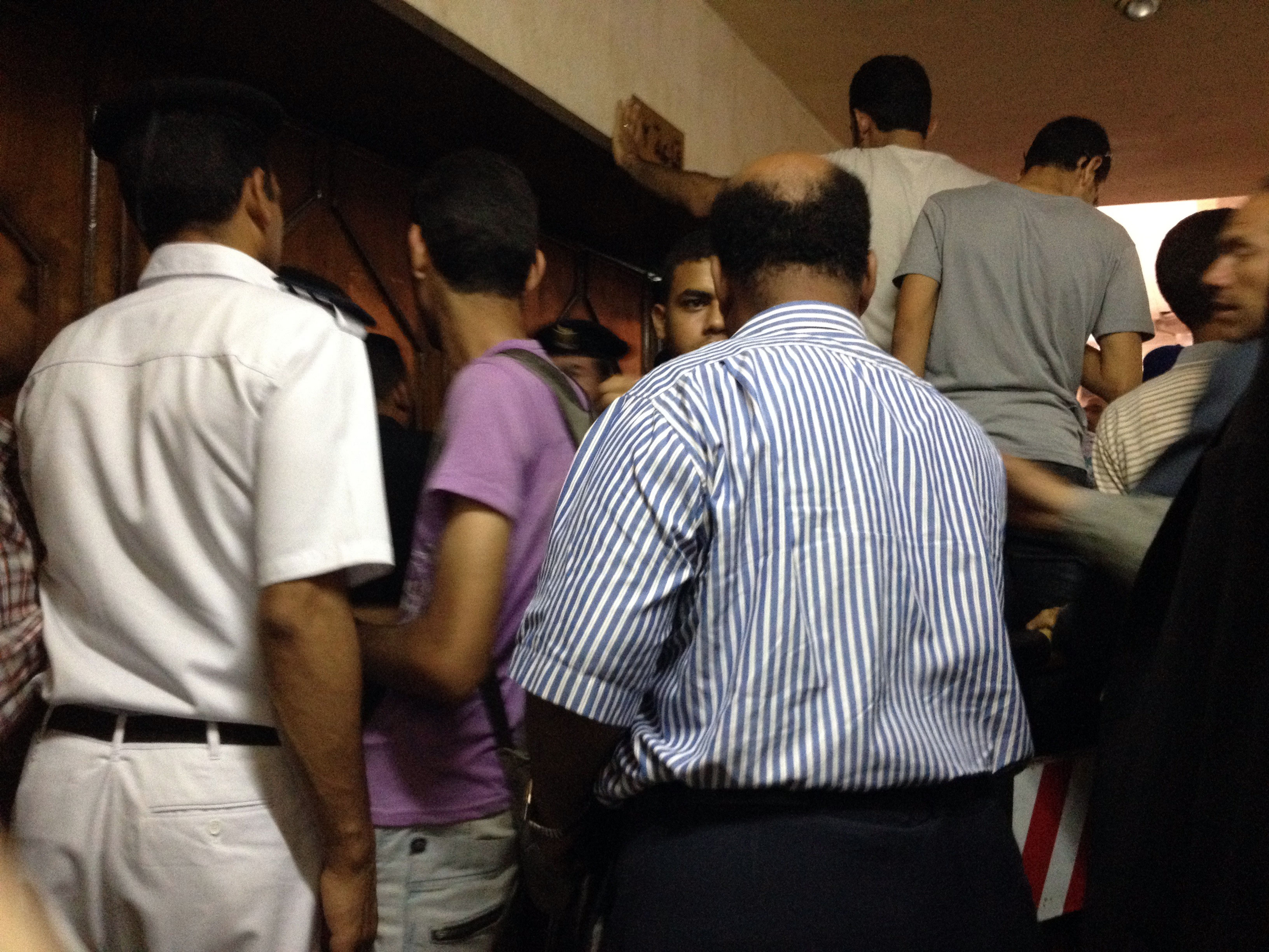 Lawyers, reporters and Muslim Brotherhood supporters banged the door of courtroom 12 - Ahmed Aboul Enein