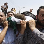 People carry the body of a six-year-old Bilal El-Lababidi during his funeral in the Jordanian town of Ramtha. The boy was allegedly shot dead by the Syrian army as he, his parents, and a dozen other refugees tried to cross the Syrian-Jordanian border to seek refuge in Jordan (photo: AFP/stringer)