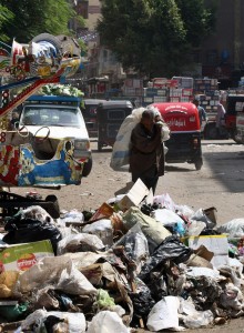 A man rummages through a pile of garbage in Cairo (file photo: AFP /CRIS BOURONCLE)  