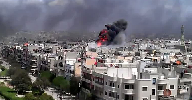 Smoke billows from sites of shelling in Homs (Photo: AFP/YOUTUBE)