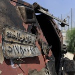 Israeli soldiers inspect a burnt armoured vehicle near the Kerem Shalom border crossing after unidentified gunmen crossed into Israel from Egypt on 6 August. The number plate reads 'Border Guards Forces' AFP PHOTO/DAVID BUIMOVITCH