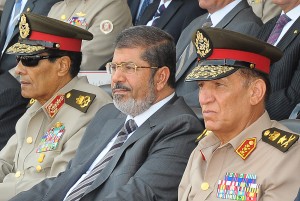  Egyptian President Mohamed Morsi (C), former head of the military council Field Marshal Mohammed Hussein Tantawi (L) and former armed forces chief Sami Anan (R) attending a graduation ceremony of military cadets in Cairo on 12 August 12,  AFP PHOTO/EGYPTIAN PRESIDENCY  