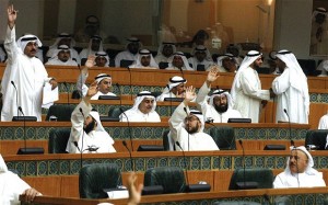 Kuwaiti MPs raise their hands during a parliament session at the National Assembly in Kuwait City (AFP PHOTO) 