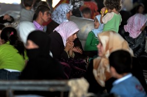 Syrian families which have been displaced due to fighting between rebel fighters and Syrian government forces are seen near the Syrian border with Turkey on 25 August  AFP PHOTO / ARIS MESSINIS