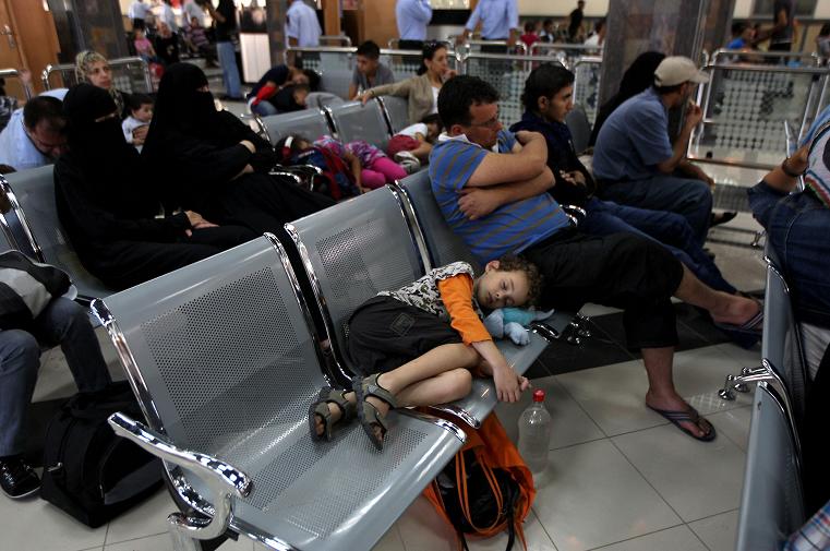 Palestinians wait in a hall at the Rafah border crossing in the southern Gaza Strip before travelling to Egypt AFP PHOTO/ SAID KHATIB