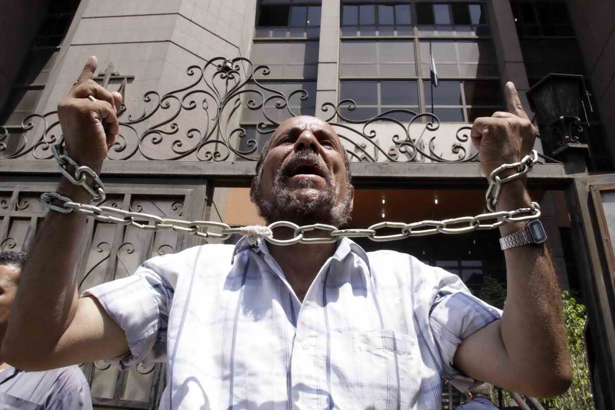 Man protests against imprisonment by the military in front of Cairo’s main court Mohamed Omar