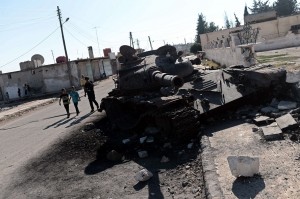 Despite Morsy’s efforts to form a Quartet to solve the Syrian crisis the fighting continues. Syrian children walk past a grounded army tank in the northern town of Azaz on 23 August AFP PHOTO/ ARIS MESSINIS