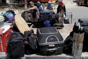 Palestinians load their luggage onto the back of a pick-up truck at the Rafah border on 14 August after Egypt reopened the crossing for limited numbers AFP PHOTO / SAID KHATIB 