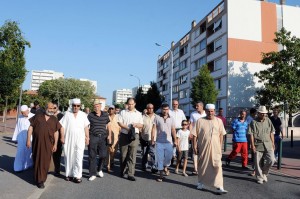 French imam (3rdL) of the Faourette mosque takes part on 14 August in a march with residents to ease people's minds, two days after clashes broke out between rival groups in the Bagatelle and Farouette deprived neighbourghoods of Toulouse, southern France  AFP PHOTO / PASCAL PAVANI