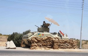 An Egyptian army vehicle keeps its position close to the Rafah border crossing with the Hamas-run Gaza Strip on 6 August AFP PHOTO/AHMED MAHMOUD
