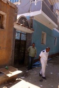 An Egyptian policeman inspects the damage outside a Coptic church on 2 August 2, 2012, caused by clashes on 1 August between Christians and Muslims in Dahshur village, on the outskirts of Cairo AFP PHOTO/TAREK EL GABBAS