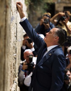 US Republican presidential candidate Mitt Romney places a message, written on paper, in the ancient stones of the Western Wall in Jerusalem's Old City on July 29, 2012 during the annual Tisha BAv (Ninth of Av) fasting and a memorial day, commemorating the destruction of ancient Jerusalem temples. Romney is meeting Israeli leaders as he seeks to burnish his foreign policy credentials and portray himself as a better friend to Israel than President Barack Obama. AFP PHOTO/MENAHEM KAHANA