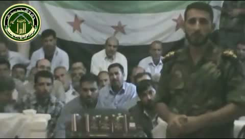 An image grab taken from a video uploaded on YouTube on 5 August 2012 allegedly shows footage of Iranians (background) kidnapped in Damascus, in which a rebel fighter alleges the hostages are elite Revolutionary Guards