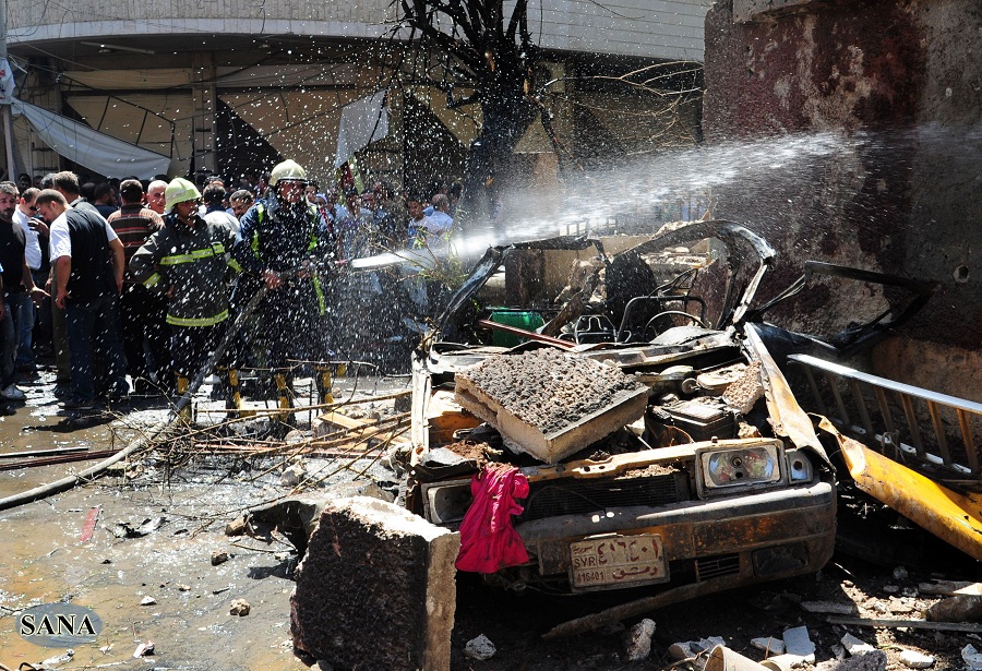A handout picture released by the Syrian Arab News Agency (SANA) shows Syrian firefighters extinguishing a fire following at the site of a car bomb that ripped through Jaramana, a mainly Christian and Druze suburb of Damascus, on September 3, 2012. AFP PHOTO/HO/SANA