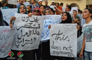 Protesters in Benghazi hold signs denouncing both the "Innocence of Muslims" film and the violent reactions to it that lead to the deaths of the US ambassador to Libya and three other US nationals Libyan Tweep Forum