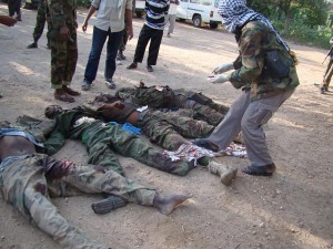 Photo received on 1 September shows Somalia's Al-Qaeda-linked Shebab militants displaying the bodies of four "enemy" soldiers killed in combat in their stronghold of Kismayo, in southern Somalia.       AFP PHOTO/HO