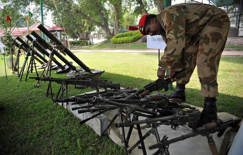 A Pakistani army soldier arranges seized weapons and ammunition in Peshawar on 29 August after a military operation against militants in the country's lawless tribal northwest AFP PHOTO/Hasham AHMED