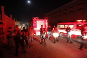Ambulances and firemen arrive following an Israeli air strike in Gaza City on 28 August  AFP PHOTO/MOHAMMED ABED