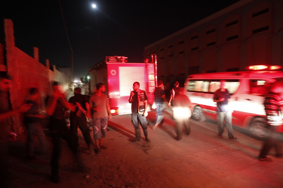 Ambulances and firemen arrive following an Israeli air strike in Gaza City on 28 August AFP PHOTO/MOHAMMED ABED