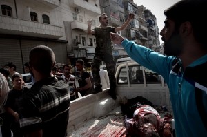 An opposition fighter shouts for help as he delivers the body of a civilian who was wounded during shelling by Syrian government forces outside a hospital in Syria's northern city of Aleppo AFP PHOTO / ARIS MESSINIS