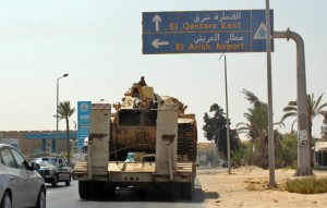 Egyptian tanks are seen being carried on the back of trucks on the Egyptian side of the border city of Rafah on 29 August AFP PHOTO / Stringer