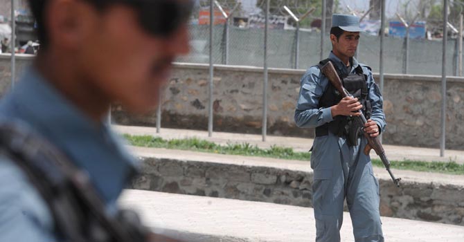 Afghan policemen stand guard at a checkpoint in Kabul (File photo) AFP PHOTO