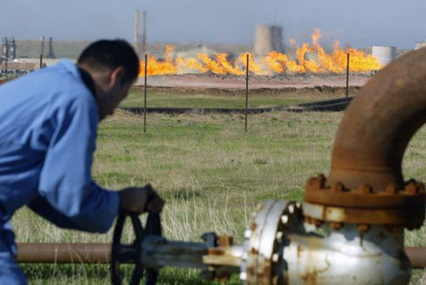 An oil worker tending to a supply pipeline in Iraqi Kurdistan AFP PHOTO