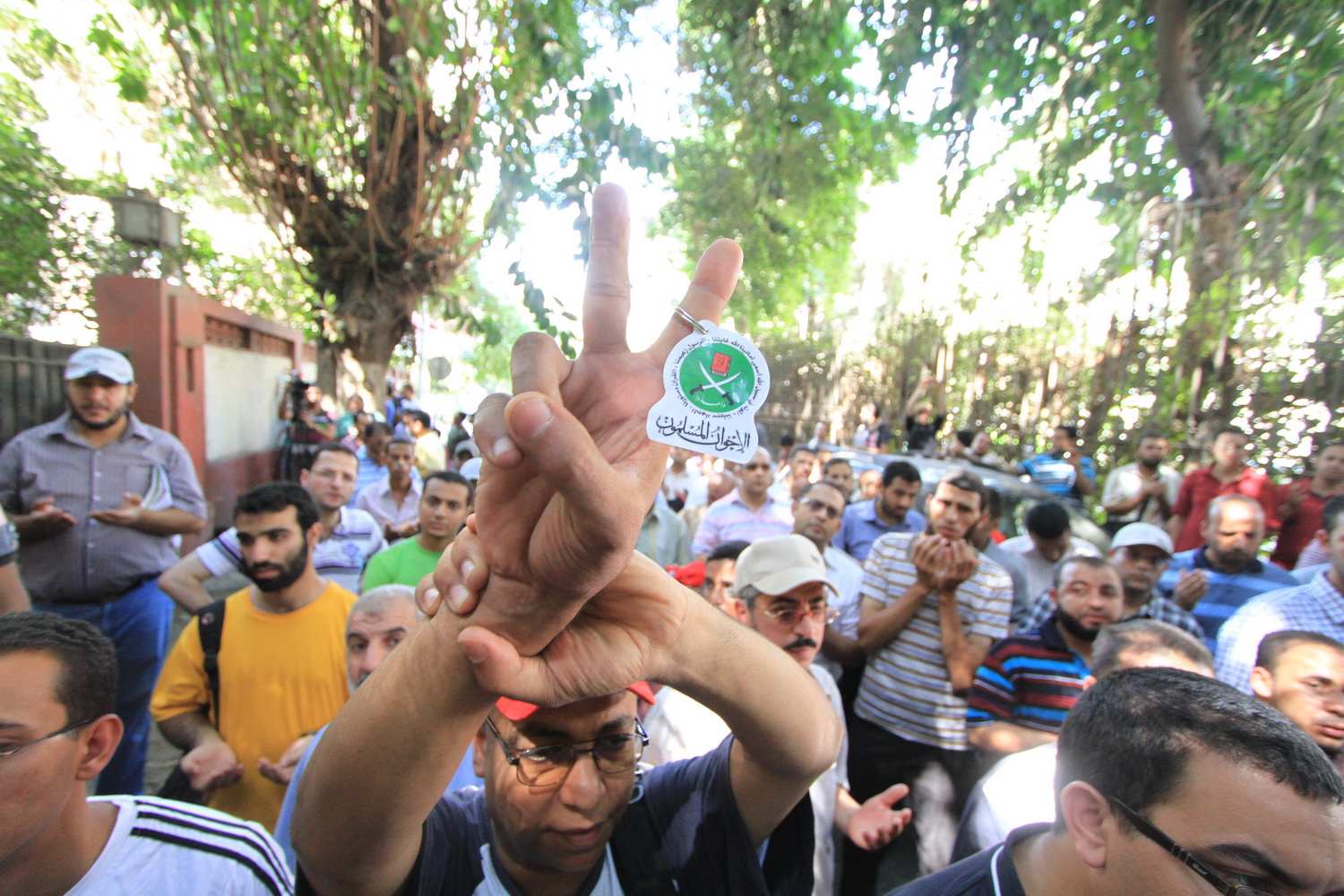 Protester carries a key ring with the Muslim Brotherhood symbol during protests in front of the Syrian embassy in Cairo Mohamed Omar
