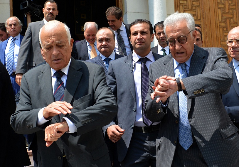UN and Arab League envoy for Syria Lakhdar Brahimi (right) and Arab League General Secretary Nabil al-Arabi look at their watches as they leave the Arab League's headquarters in Cairo AFP PHOTO / KHALED DESOUKI