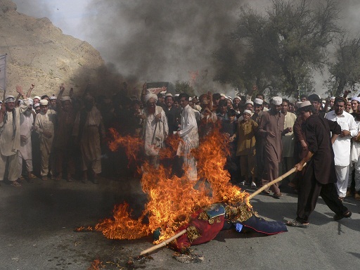 Afghan demonstrators torch an effigy of US President Barack Obama during an anti-US demonstration in Ghanikhail district of Nangarhar province on 14 September AFP PHOTO / NOORULLAH SHIRZADA