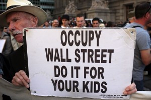 A protester with 'Occupy Wall Street' holds up a sign during demonstrations in New York City. The 'Occupy Wall Street' movement, which sparked international protests and sympathy for its critique of the global financial crisis, is commemorating the first anniversary of its earliest protest.  AFP PHOTO / Spencer Platt