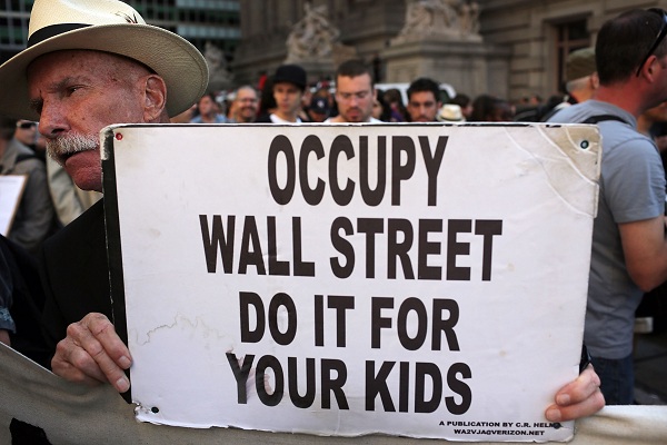 A protester with 'Occupy Wall Street' holds up a sign during demonstrations in New York City. The 'Occupy Wall Street' movement, which sparked international protests and sympathy for its critique of the global financial crisis, is commemorating the first anniversary of its earliest protest. AFP PHOTO / Spencer Platt