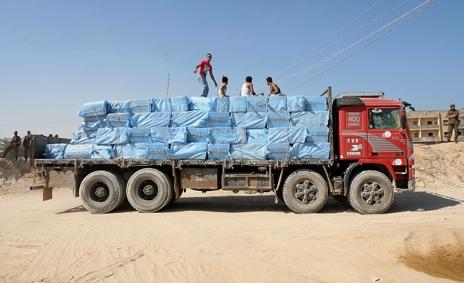 Economic restrictions put into place by the Israeli government encourage a thriving black market trade, a Palestinian truck carrying goods smuggled through tunnels leaves the Gaza-Egypt border in Rafah (File photo) AFP PHOTO/ SAID KHATIB