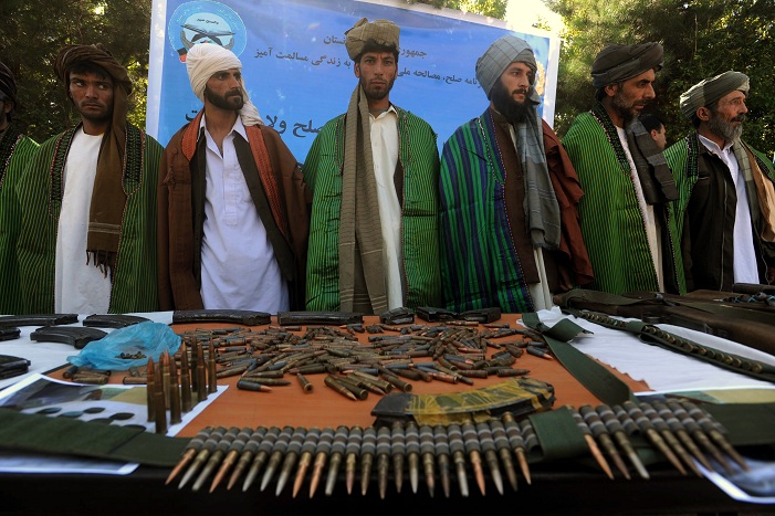 Former Taliban fighters display their weapons as they join Afghan government forces during a ceremony in Herat province on 18 September 18, 2012. Government authorities banned all Pakistani newspapers claiming "The papers print Taliban propaganda" AFP PHOTO / AREF KARIMI