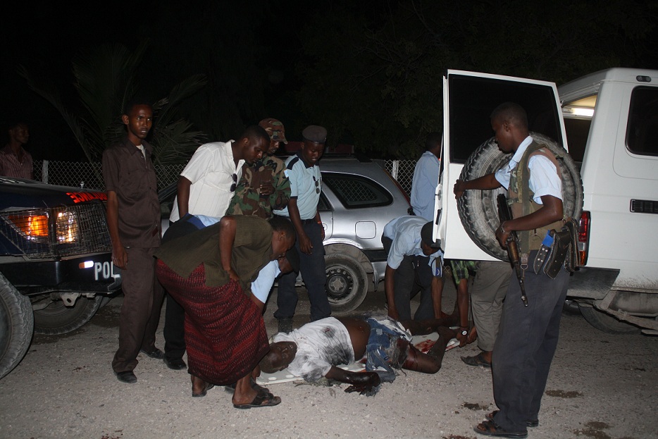 Police gather at the scene of an attack after two suicide bombers blew themselves up in a restaurant in Mogadishu’s Hamarweyne district AFP PHOTO / ABDURASHID ABDULLE ABIKAR