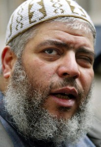 Muslim cleric Abu Hamza al-Masri is escorted from the Central Criminal Courts in London in January 2003  AFP PHOTO / ADRIAN DENNIS