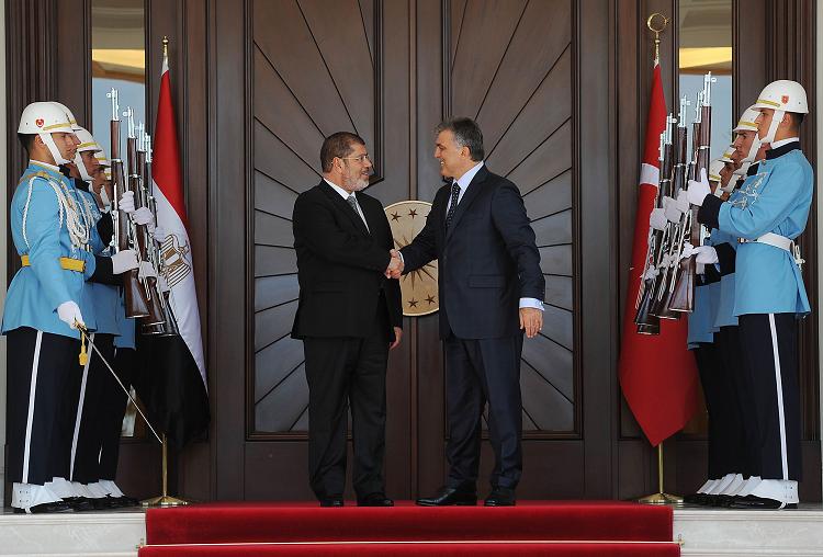 Turkey's President Abdullah Gul (right) welcoming his Egyptian counterpart Mohamed Morsy at the Presidential Palace of Cankaya in Ankara AFP PHOTO / MUSTAFA OZTARTAN