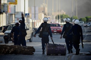 Bahraini riot policeman flashes the victory sign during clashes with protesters in solidarity with jailed Bahraini opposition activists in Malekia, on the outskirts of the capital Manama on 4 September  AFP PHOTO/MOHAMMED AL-SHAIKH