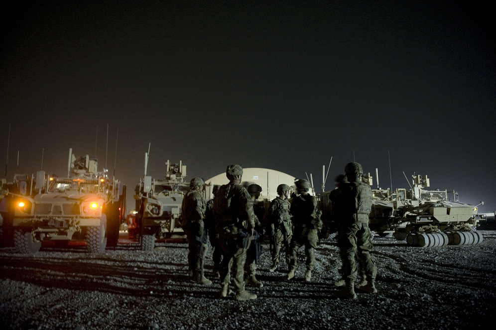 Infantry men attend a briefing prior to embarking on a night patrol from Lindsey foward operating base on 15 September in Kandahar province AFP PHOTO / TONY KARUMBA