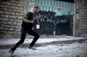 A Syrian rebel aims his weapon during clashes with government forces in the Ezza district of the northern city of Aleppo on 8 September AFP PHOTO / ZAC BAILLIE 