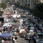 Egyptians mix road and market space in crowded road conditions in Cairo AFP PHOTO / MAHMUD HAMS