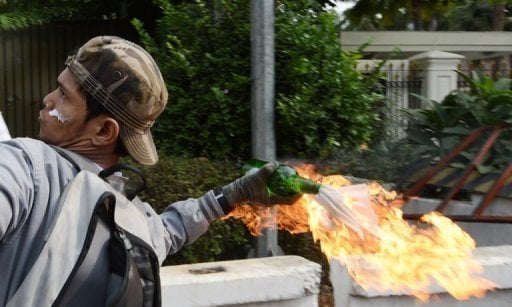 An Indonesian protester hurls a molotov coctail towards the US embassy in Jakarta AFP / Adek Berry