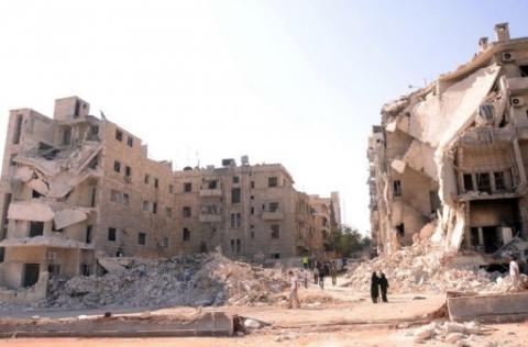 People walk past a row of destroyed buildings near the Al-Hayat Hospital in the northern Syrian city of Aleppo on September 10. Syrian troops on Tuesday pounded Aleppo to thwart a rebel advance in Syria's second city, activists said, as Hollywood star Angelina Jolie visited a Jordanian camp for refugees from the conflict. AFP Photo